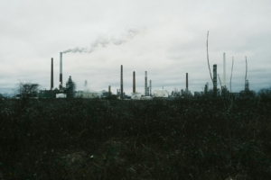 a factory with smoke coming out of it's stacks